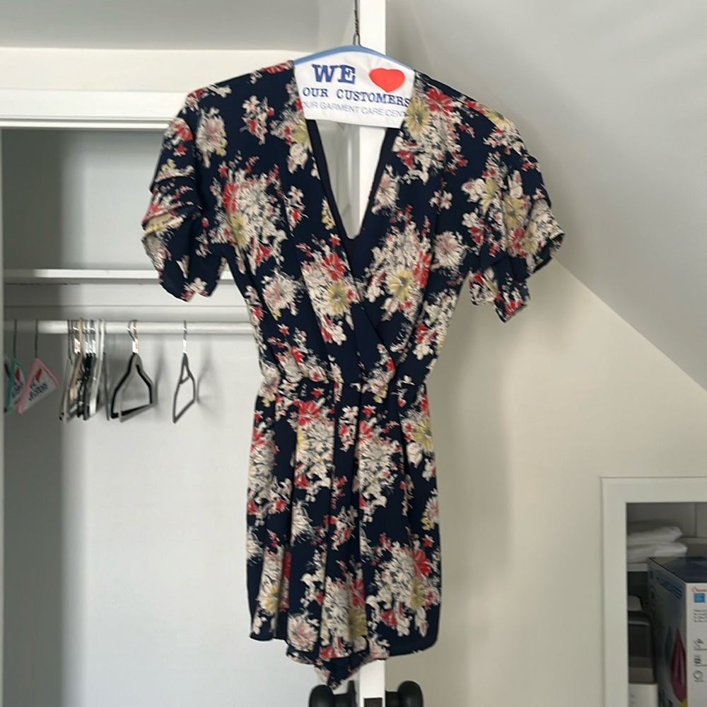 Floral navy blue romper. Deep V front and back